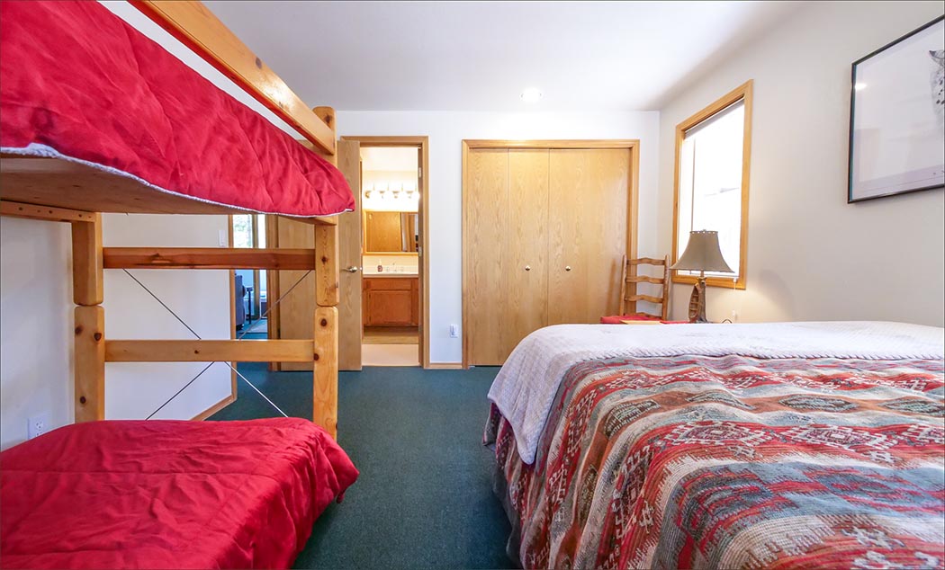 Lower level queen bed plus two twin beds in the bunk.