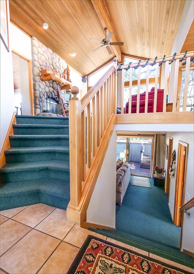 Dramatic entrance with vaulted ceilings and custom furnishings.